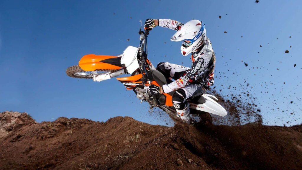 Adrenaline-Packed Motocross Wallpaper: Rider in Action