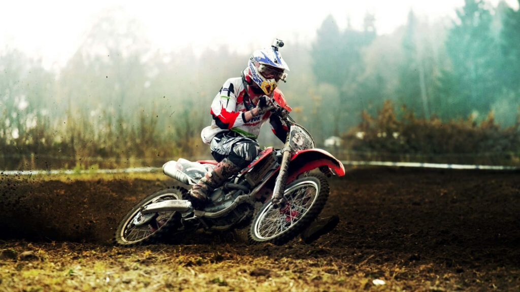 Dynamic Motocross Rider Wallpaper: Energy & Excellence on Dirt Track