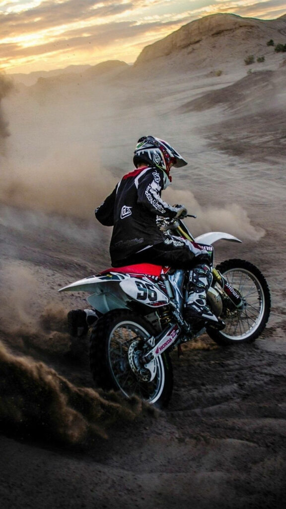 Dynamic Motocross iPhone Wallpaper: Rider in Sunset Terrain