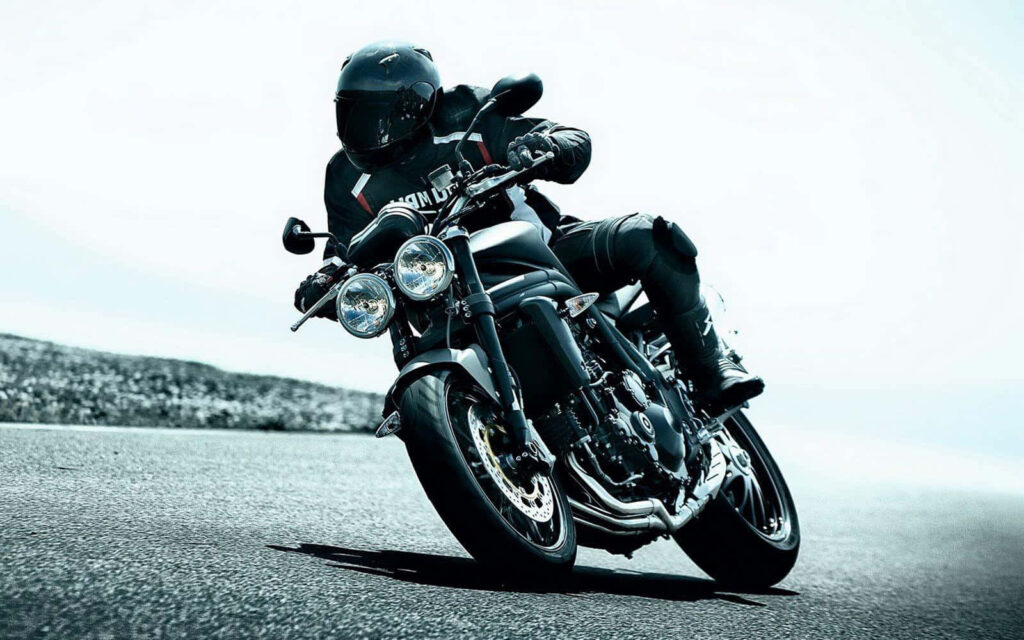 Thrilling Motorbike Rider Wallpaper: Adventure on Smooth Asphalt Road