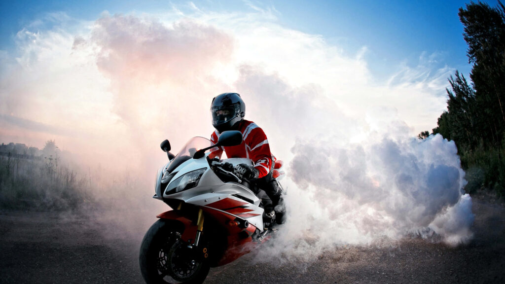 Thrilling Motorcycle Burnout Wallpaper Against Clear Sky & Nature