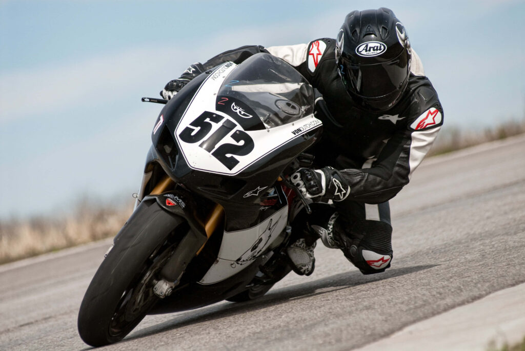 Thrilling Motorcycle Racer Turning - Dynamic Wallpaper Background
