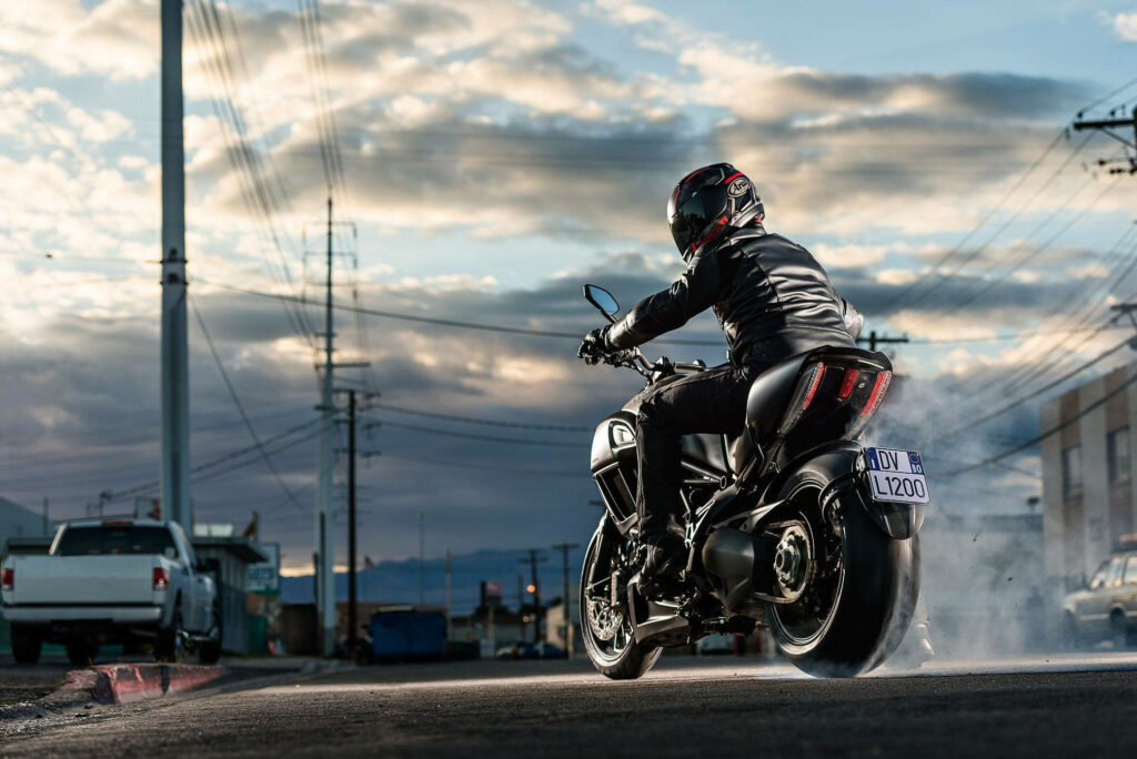 Thrilling Motorcycle Rider Wallpaper: Urban Action & Tire Smoke