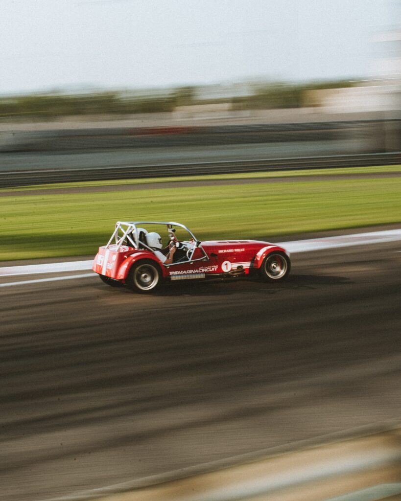 Dynamic Red Race Car Wallpaper: Thrilling Motion and Excitement