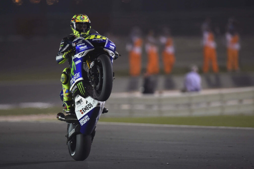 VR46 Night Racing Wallpaper: Impressive Wheelie Under Lights