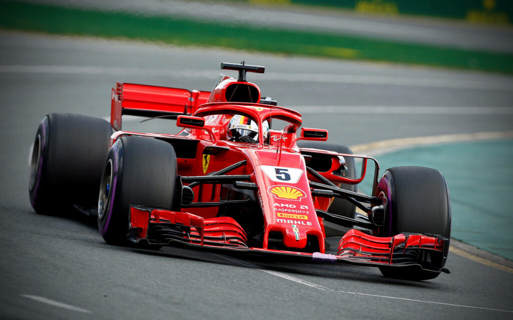 Blazing Speed: Ferrari F1 2018 in Action with F1 Racer at the Wheel - Captivating Background Image Wallpaper