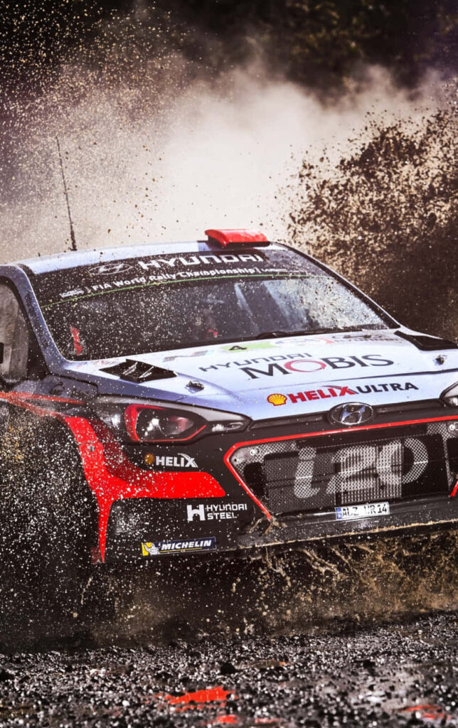 Thrilling WRC Wallpaper: Rally Car Action on a Muddy Road