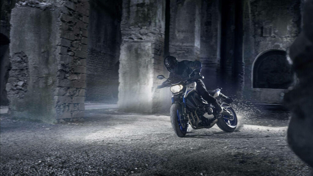 Thrilling Dynamic Wallpaper: Man Riding Yamaha MT-15 in Rugged Terrain