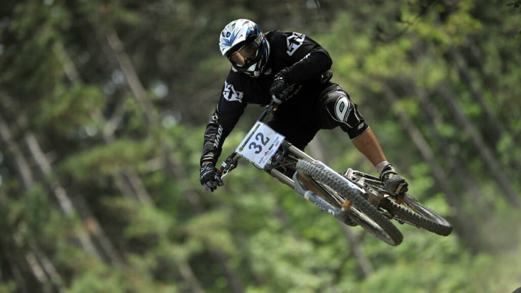 Dirt Devil: The Majestic Thrills of Downhill Mountain Biking Wallpaper