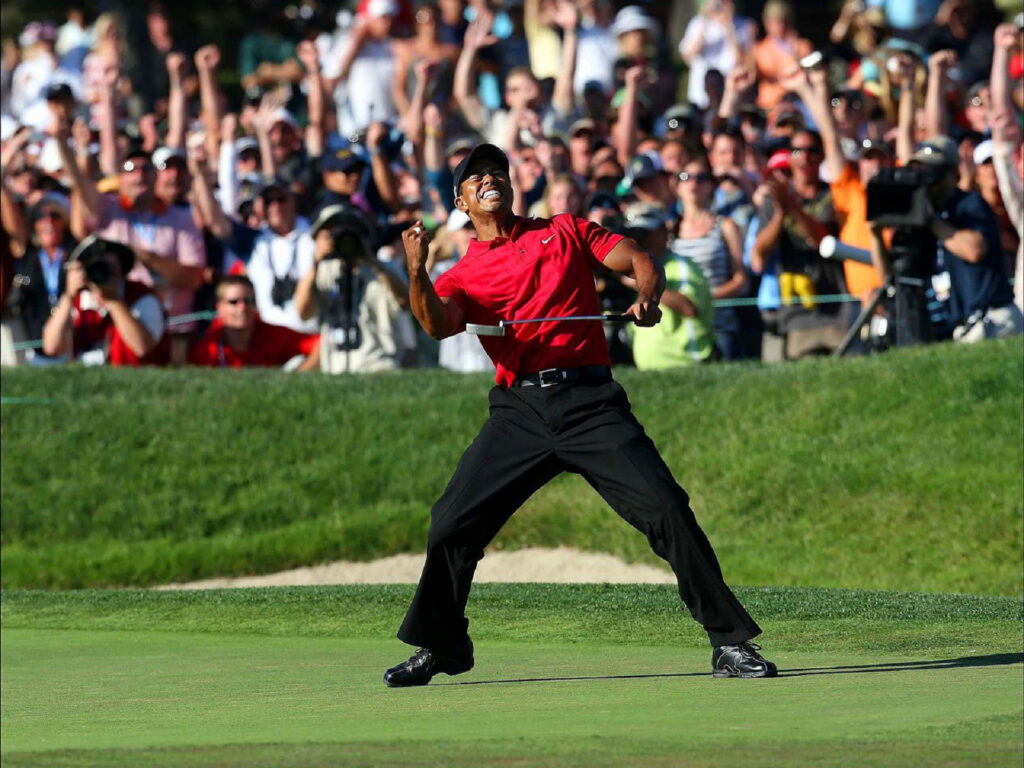 Tiger Woods celebrating a golf victory with energetic crowd dynamic iPhone wallpaper background