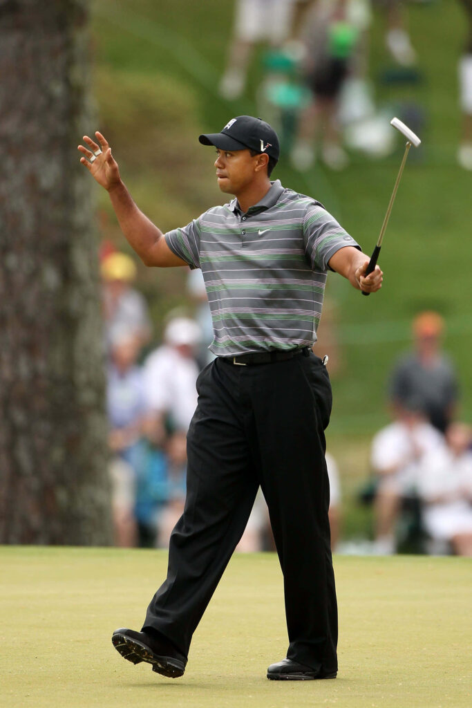 Tiger Woods confident pose on golf course iconic style wallpaper perfect for iPhone background