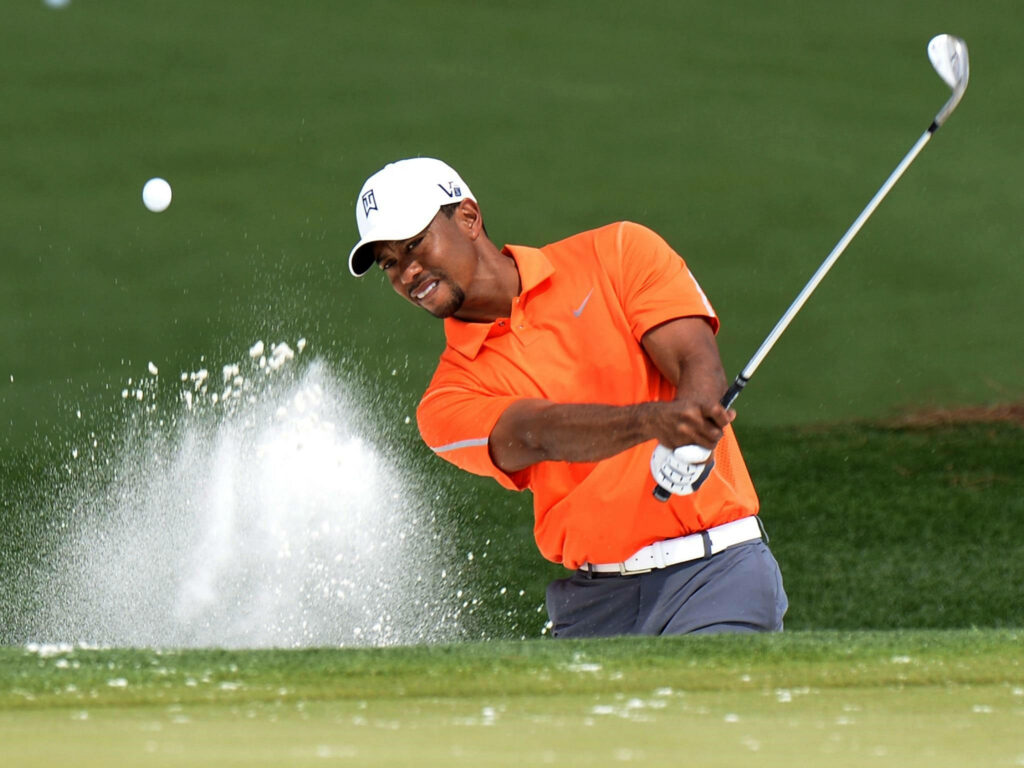 Tiger Woods hitting bunker shot at 2013 Masters on lush green course dynamic golf wallpaper