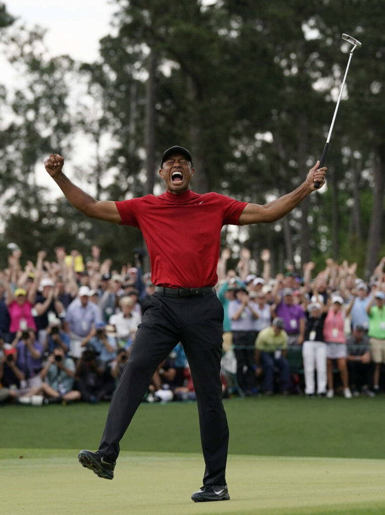 Tiger Woods in red shirt celebrating golf victory with cheering fans dynamic iPhone wallpaper background