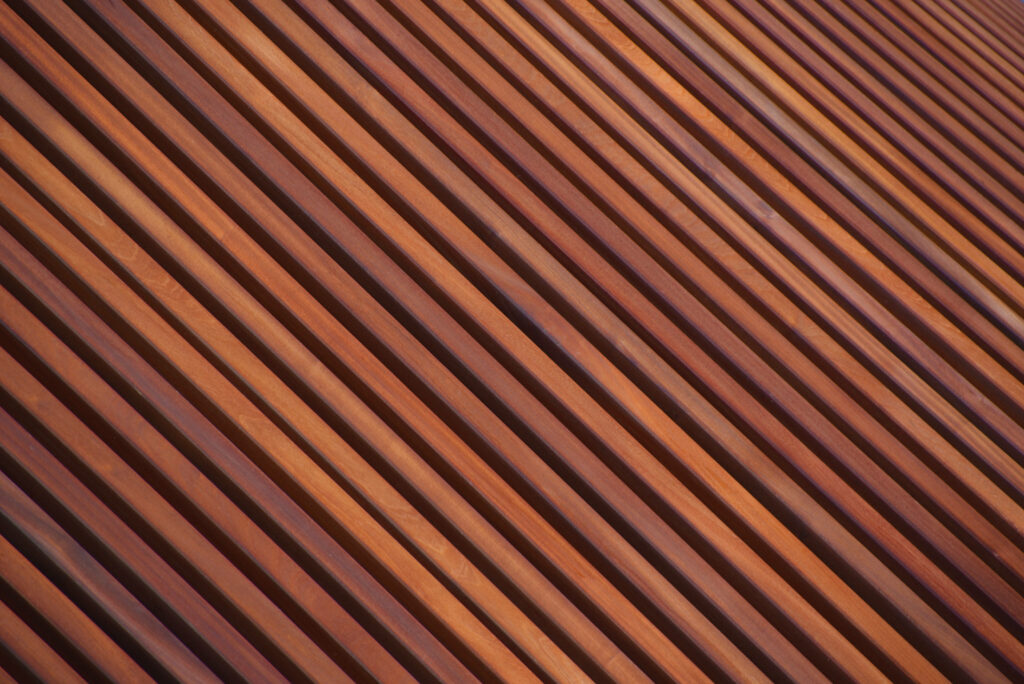 Rustic Elegance: Captivating Tilt-angle Shot of Richly Colored Timber Slats showcasing a Striking Wood Texture Background Wallpaper