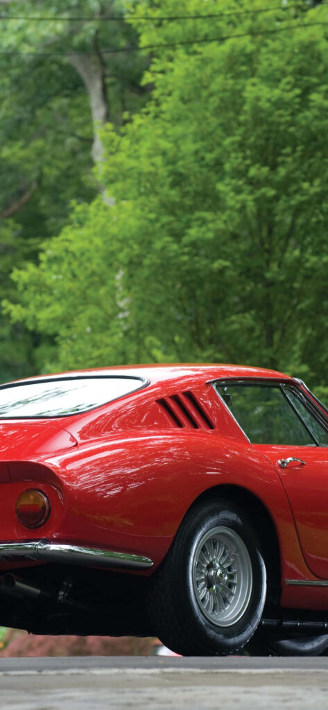 Cruising in Elegance: The Timeless Appeal of a Vintage Ferrari on a Scenic Grand Tour Wallpaper