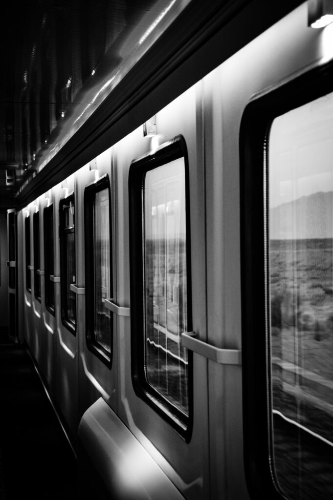 Timeless Black and White Train Interior Wallpaper with Scenic Windows