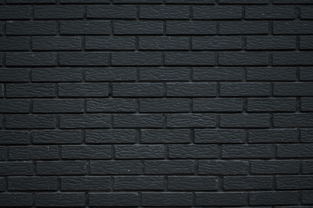 Timeless Sophistication: A Captivating Black Brick Wall Wallpaper
