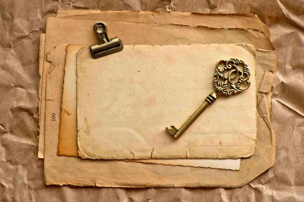 Vintage-style wallpaper with sepia paper aged key metal clip rustic nostalgic background