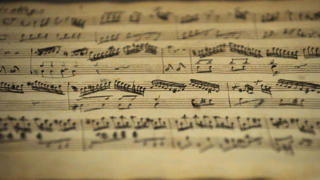 Timeless Elegance: Handwritten Musical Notes Wallpaper Background