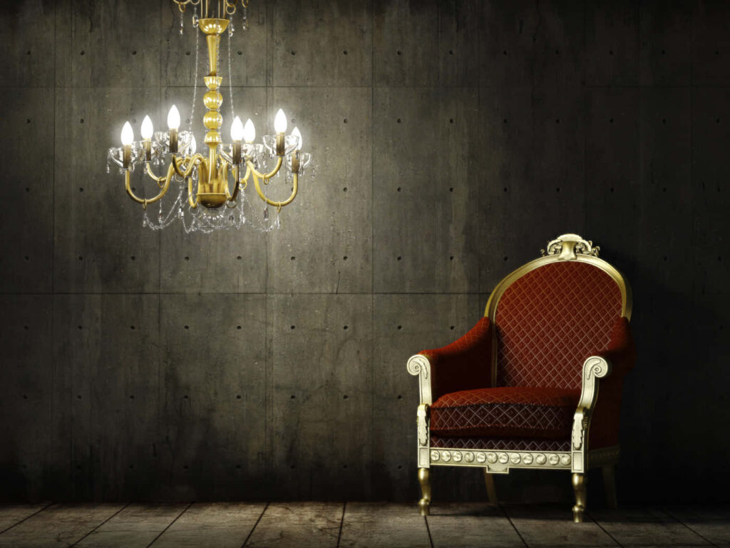 Vintage Elegance: A Classic Red Chair and Chandelier Against a Black Wallpapered Backdrop