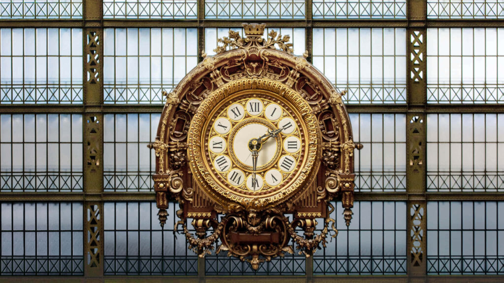 Victorian Timepiece: The Grand Clock of Musée d'Orsay Adorning a Striking Backdrop Wallpaper