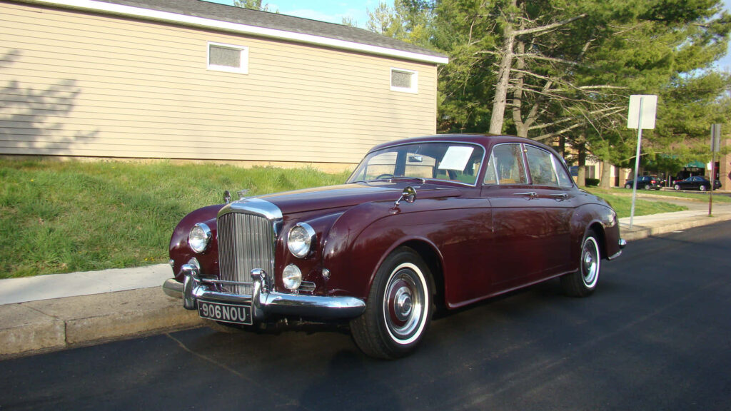 Timeless Elegance: Bentley S2, a Classic Luxury Car, Gracing a Serene Outdoor Canvas Wallpaper