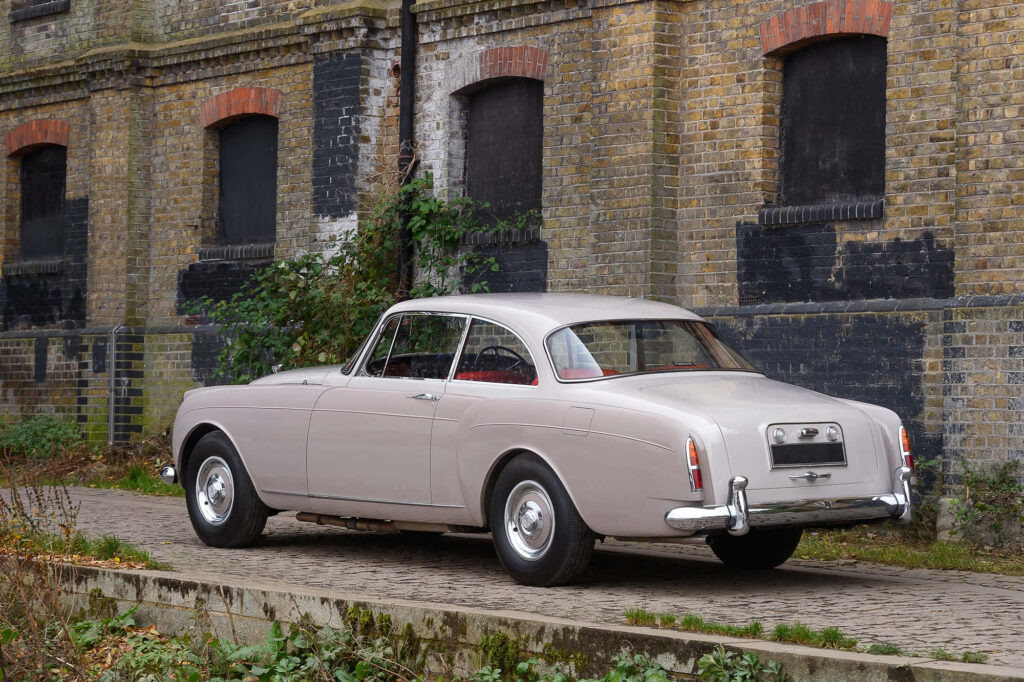 Vintage Bentley S2 Exuding Timeless Elegance Amidst Verdant Haven Wallpaper