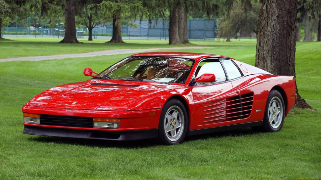 Timeless Motion: Capturing the Iconic Elegance of a Red Ferrari Testarossa on a Scenic Journey Wallpaper