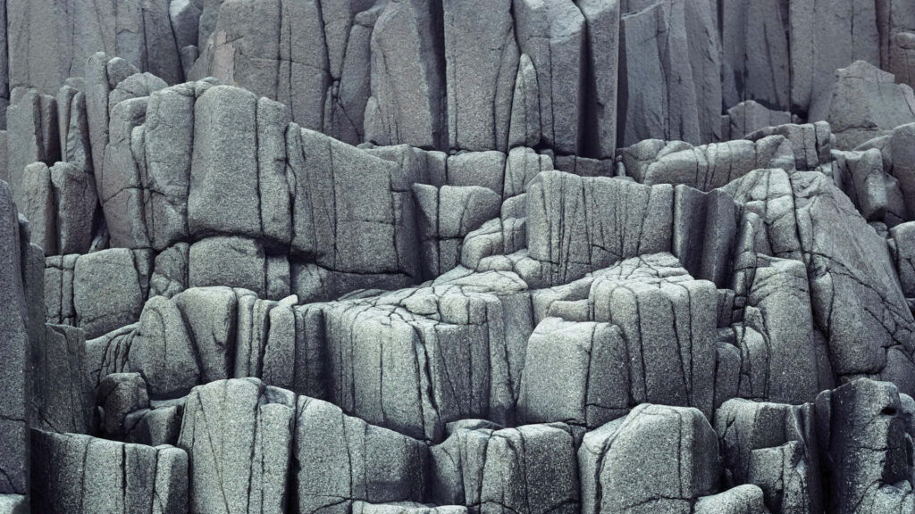 Timeless Beauty: Captivating Ancient Columnar Basalt Rocks Formation Wallpaper