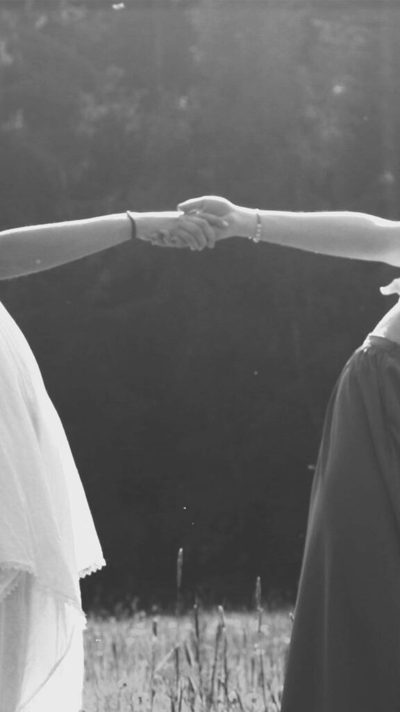 Timeless Handshake: Unity in Grayscale Natural Background Wallpaper