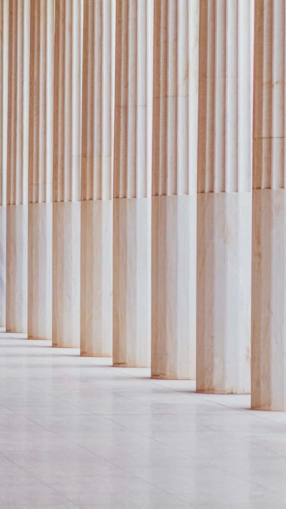 Timeless Greek Architecture Wallpaper: Elegant Marble Pillars Background