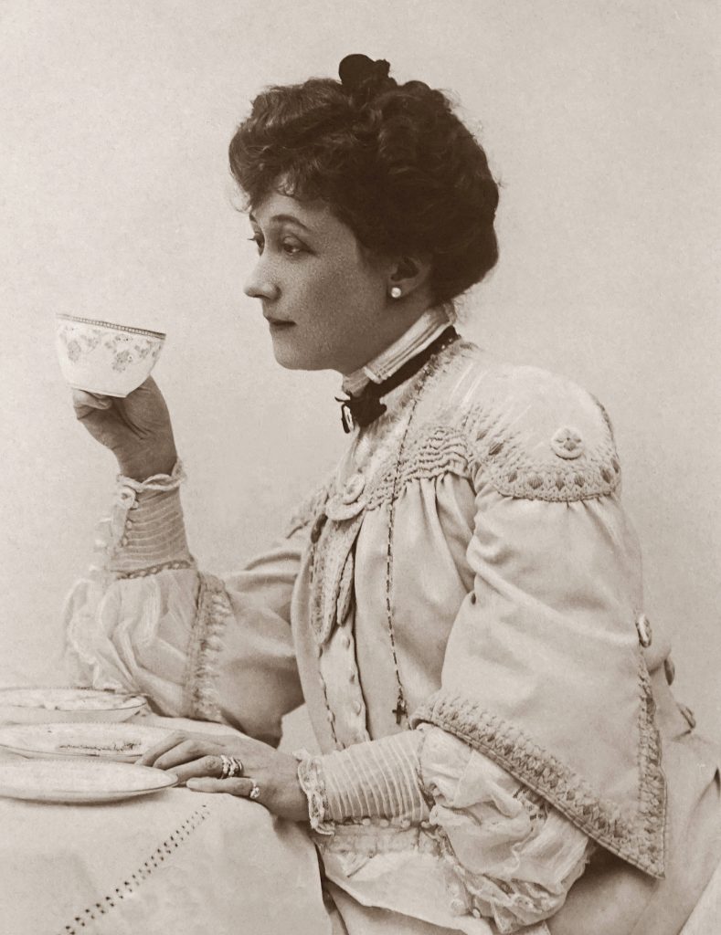 Sepia Victorian woman side-profile vintage portrait lace bodice holding floral teacup wallpaper background