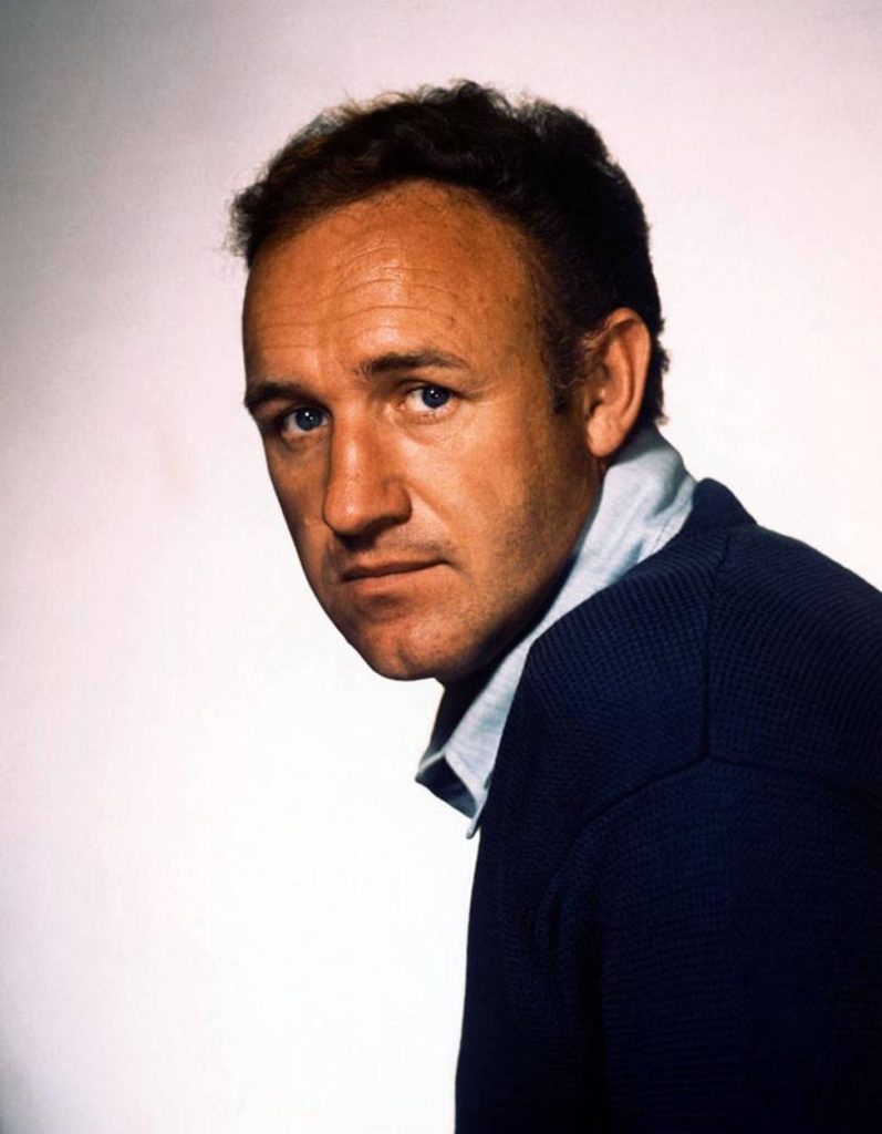 Vintage portrait of young Gene Hackman with blue eyes navy sweater classic Hollywood style Wallpaper