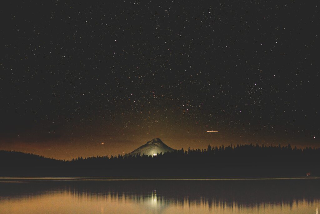 Timothy Lake night landscape with starry sky mountain silhouette and forest reflection calm water Wallpaper