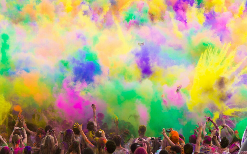 Rainbow Clouds of Powder: A Joyous Holi Celebration Wallpaper