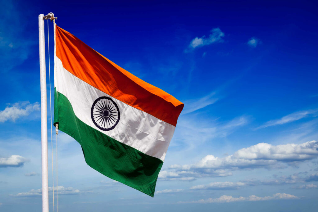 Pride in the Sky: Indian Flag Against a Clear Blue Background Wallpaper