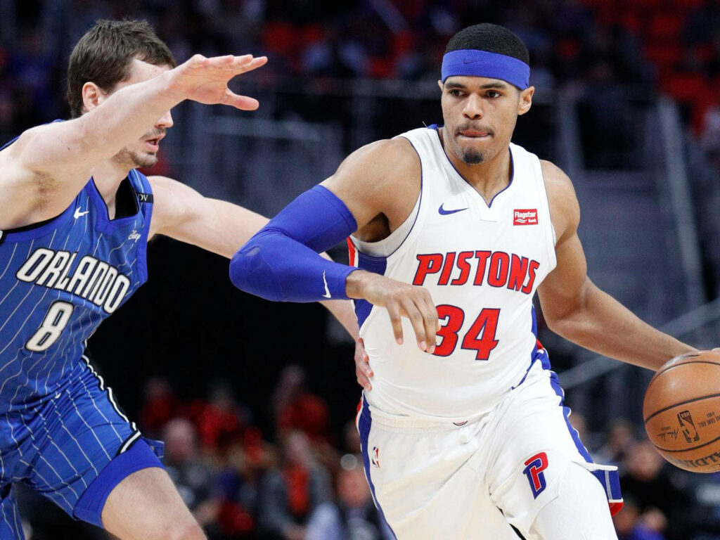 Tobias Harris Detroit Pistons drives past Orlando Magic defender intense basketball action wallpaper
