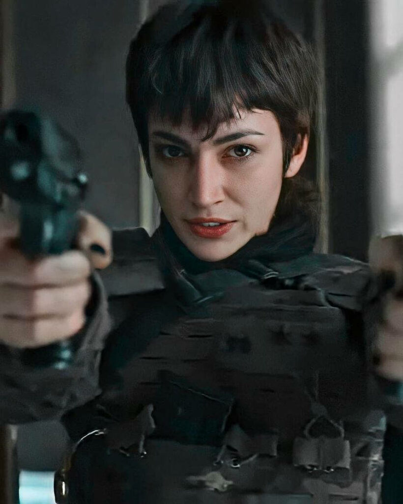 Tokyo's Intense Money Heist Stance: Twin Guns Unleashed in Mysterious Shadows Wallpaper