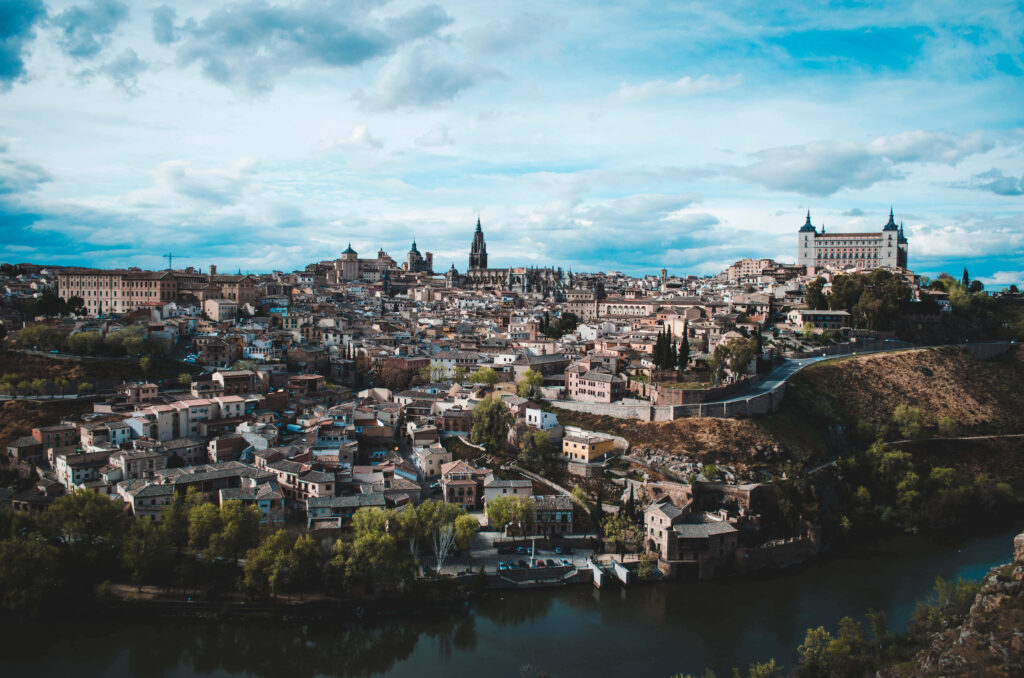 Toledo Cathedral Morning View: Serene Sky & Cityscape Wallpaper