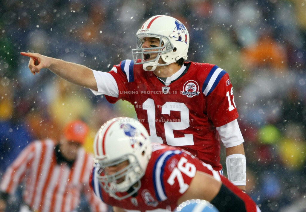 Tom Brady Action Wallpaper: Patriots Star on Snowy Field
