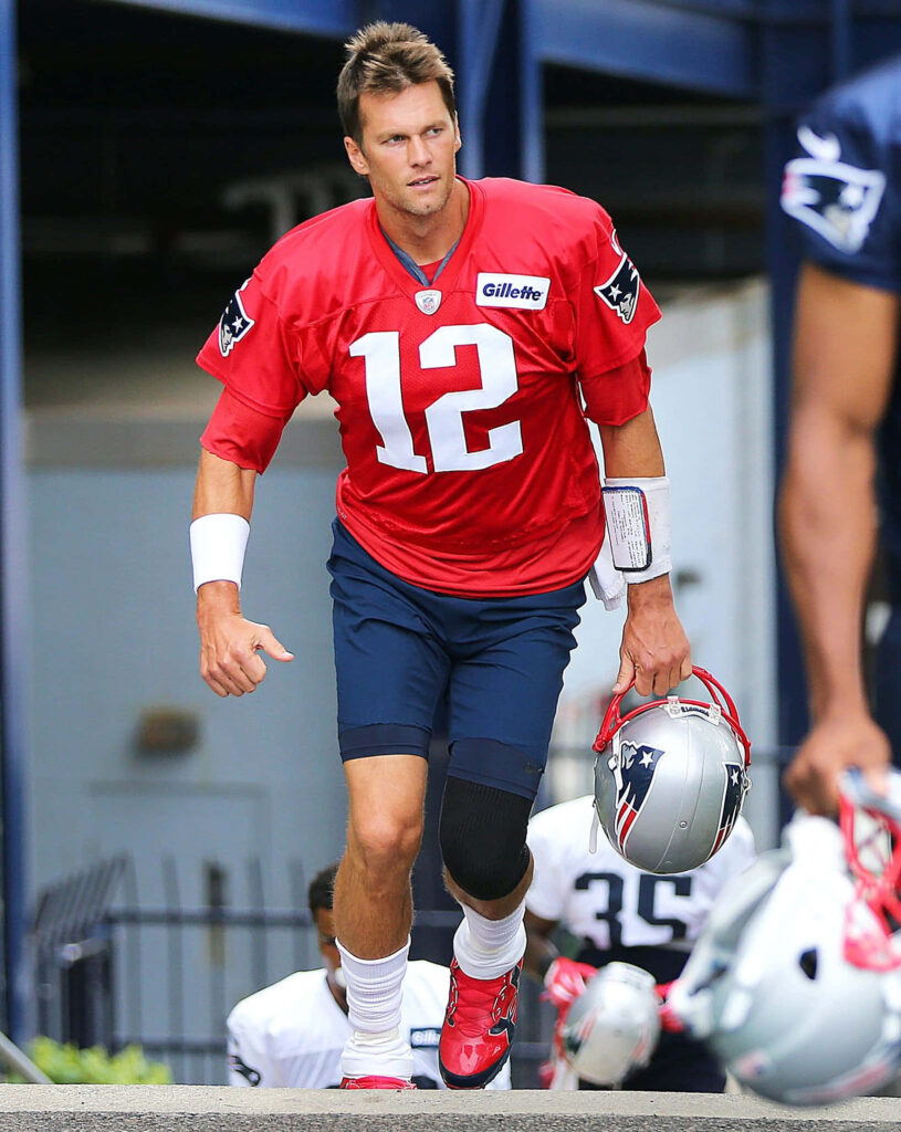Intense Tom Brady Focused in Red Jersey - Action Wallpaper Background