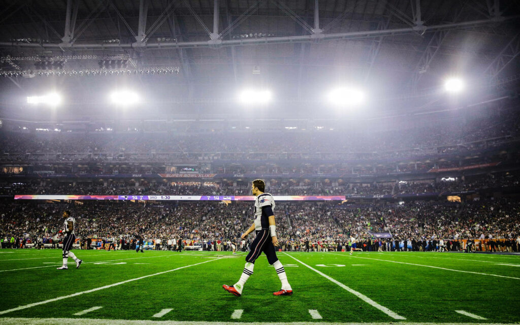 Tom Brady Walking in Packed Patriots Arena - Stunning Wallpaper Background