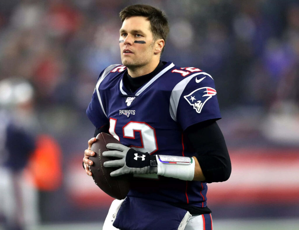 Tom Brady Wallpaper: Legendary QB in Iconic Uniform on Field