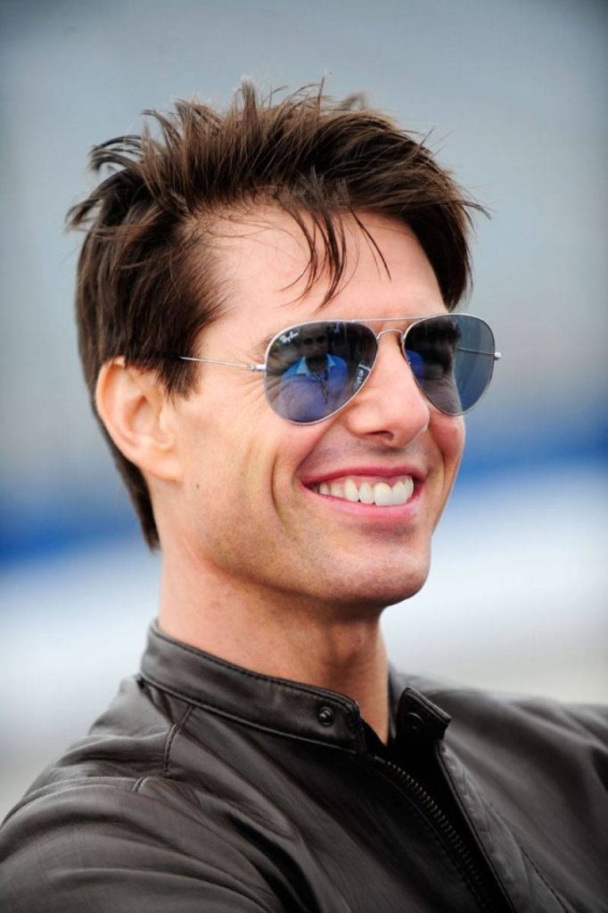 Tom Cruise smiling in aviator sunglasses and leather jacket iconic cool heartthrob wallpaper