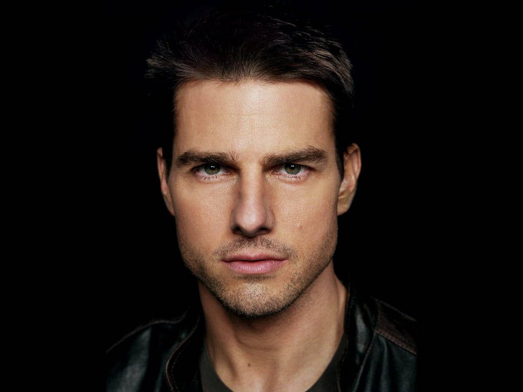Tom Cruise high definition portrait with intense gaze dramatic lighting black background wallpaper