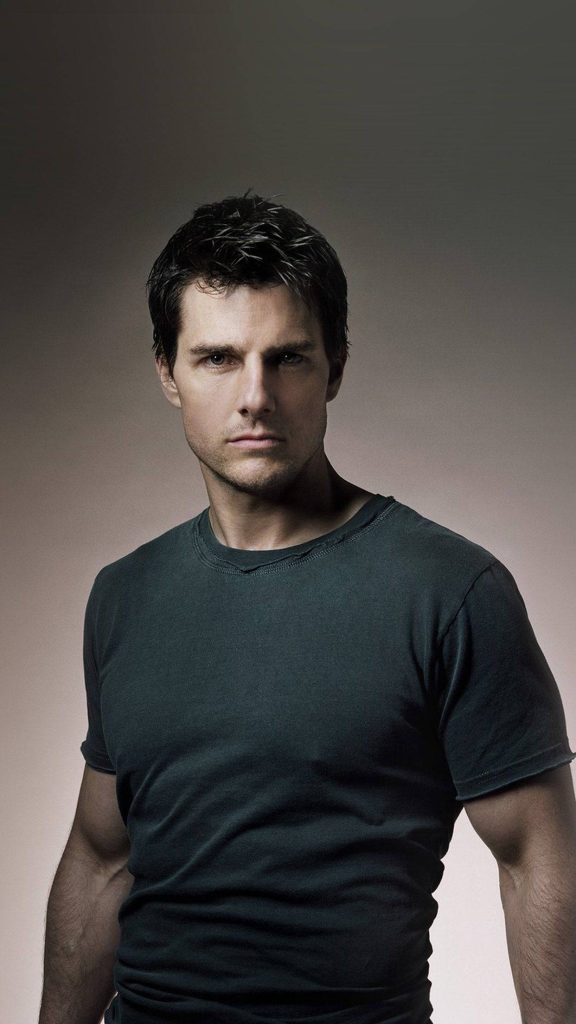Tom Cruise studio portrait mobile wallpaper with intense gaze dark t-shirt neutral background
