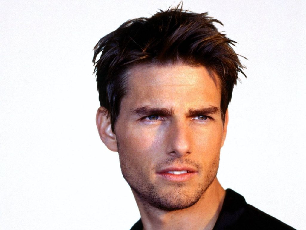 Tom Cruise portrait with tousled dark hair intense gaze light stubble cinematic wallpaper background