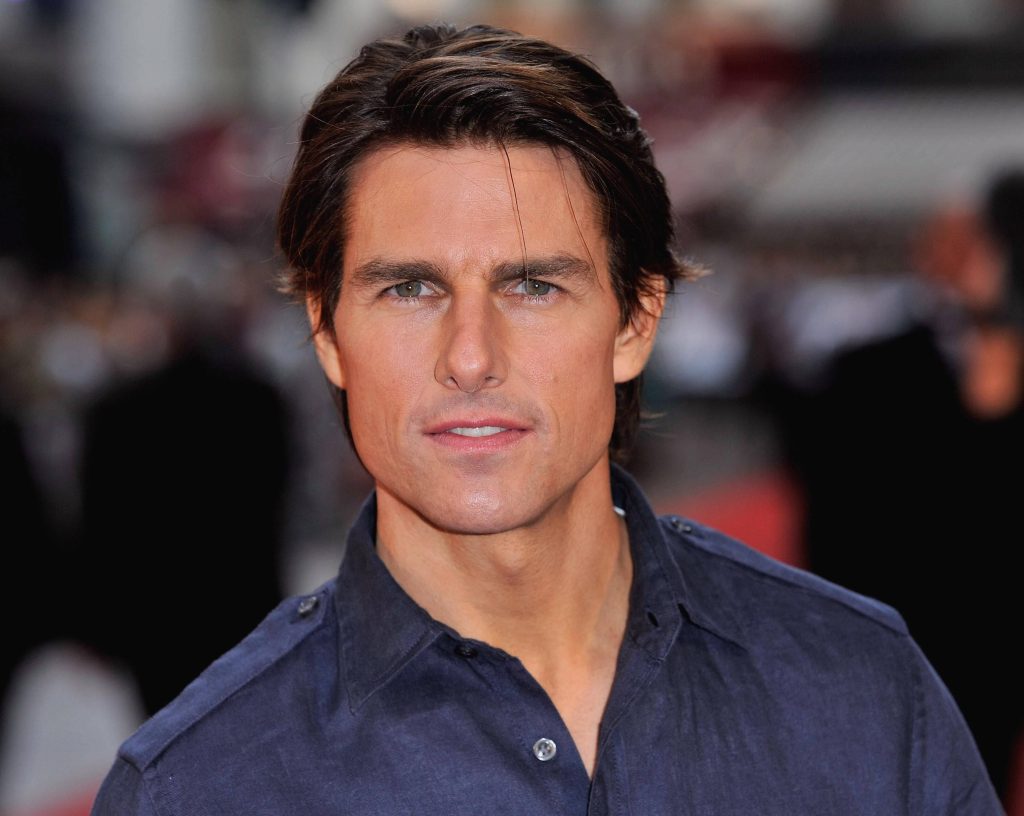 Tom Cruise portrait in dark shirt with soft lighting red carpet background wallpaper