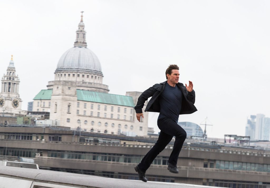 Tom Cruise running in front of Londons St Pauls Cathedral intense action hero wallpaper