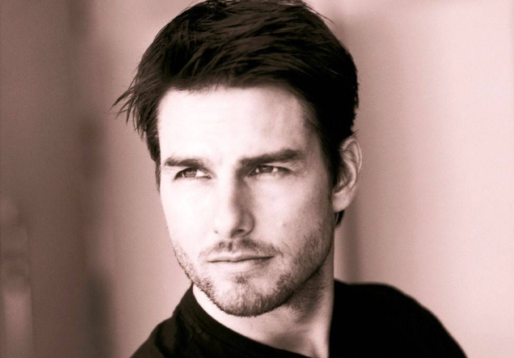Tom Cruise portrait with dark hair light stubble warm sepia tone minimalist wallpaper background